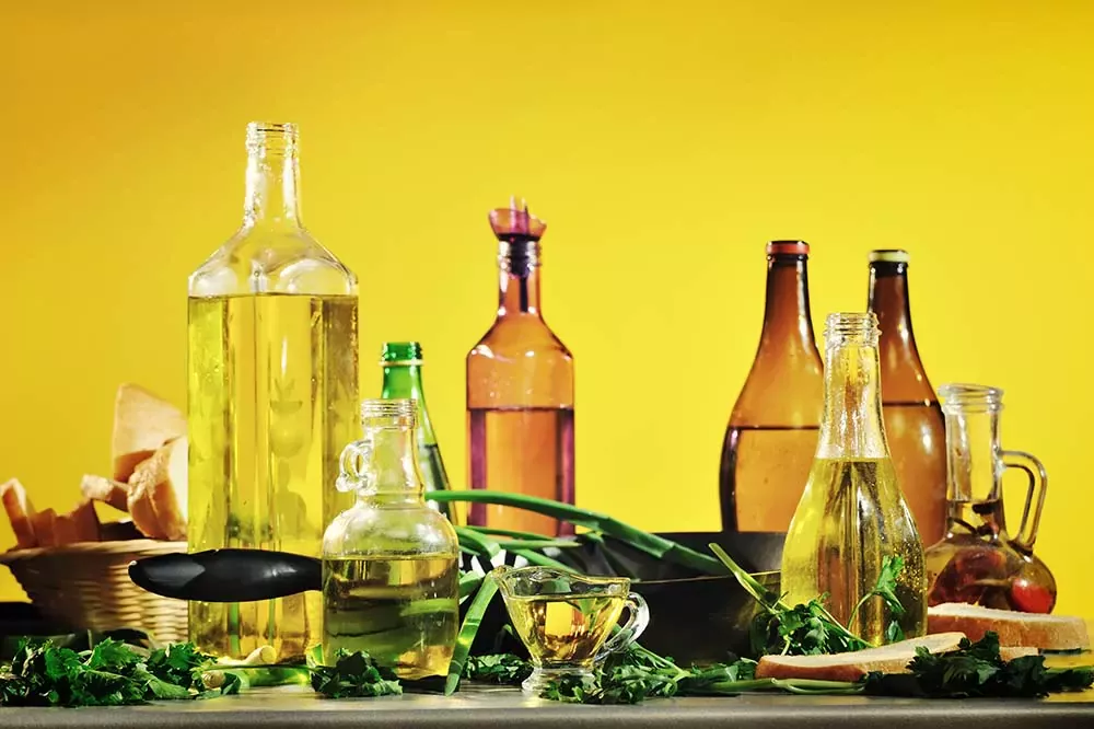 Various types of vegetable oils arranged on a table