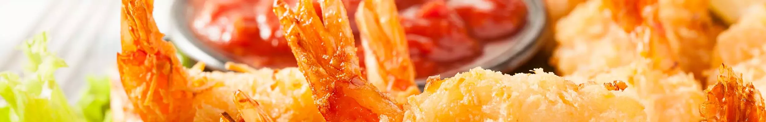 Deep fried breaded shrimp and cocktail sauce