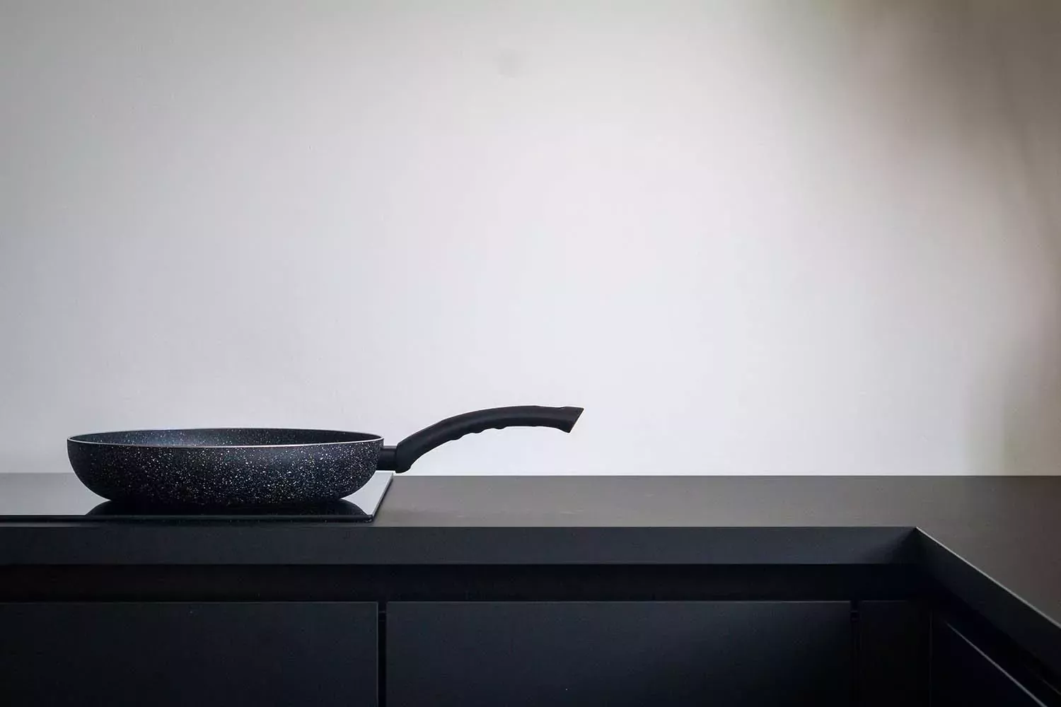 Pan on a glass stove top in a modern kitchen