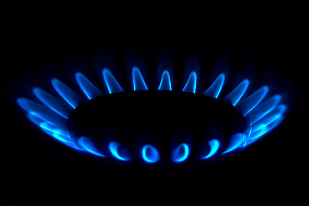 Gas Flame on a stove in the dark burning blue