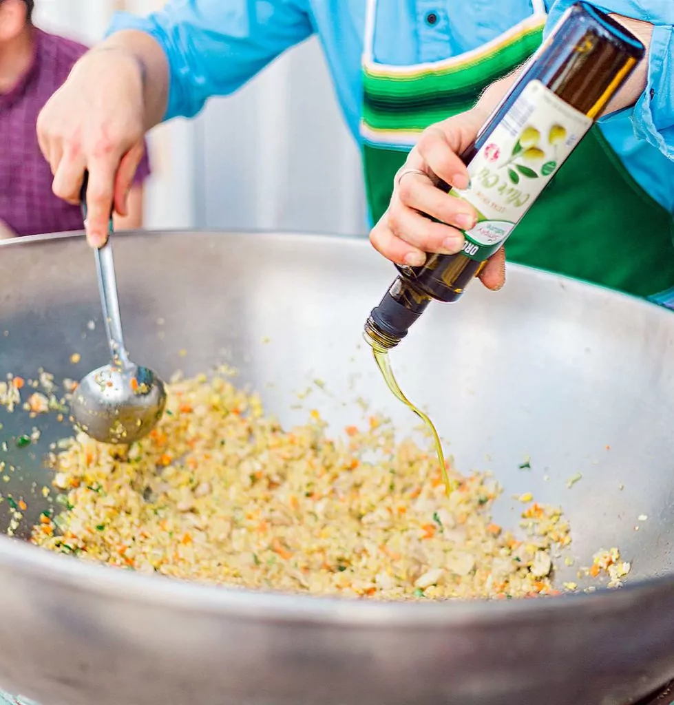Mixing the sauce into fried rice on this gigantic wok